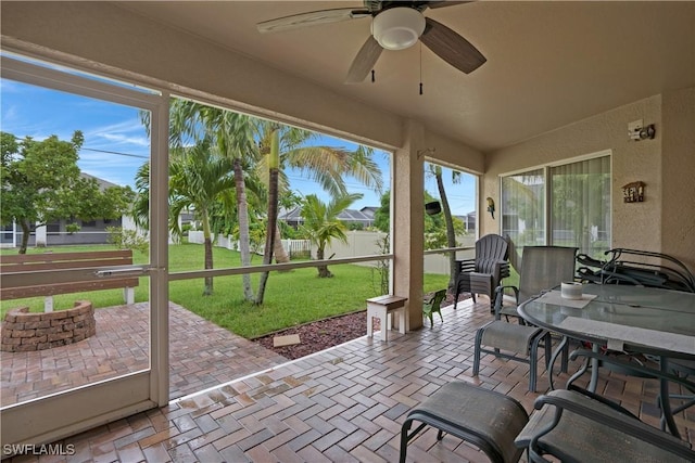 sunroom / solarium with plenty of natural light and ceiling fan