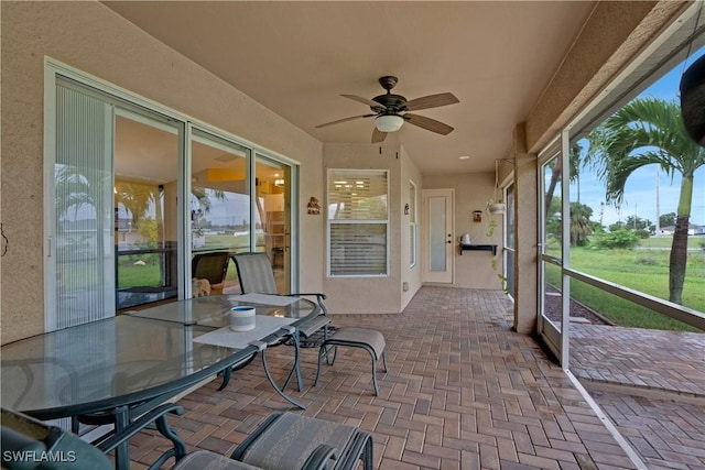 sunroom with a ceiling fan