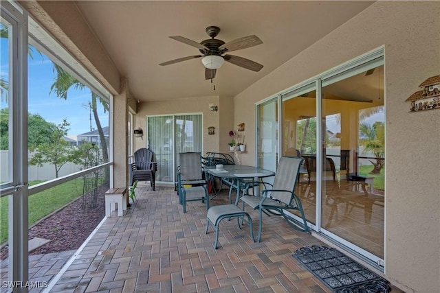 sunroom / solarium featuring ceiling fan