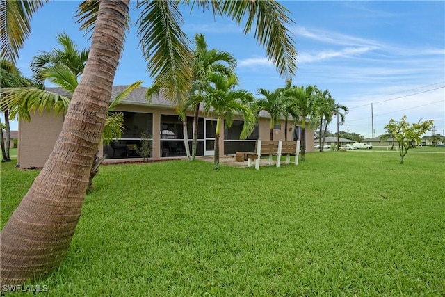 view of yard with a sunroom