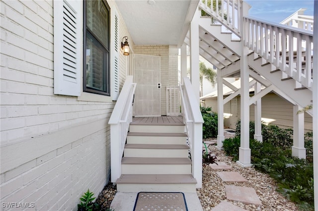 view of exterior entry with brick siding