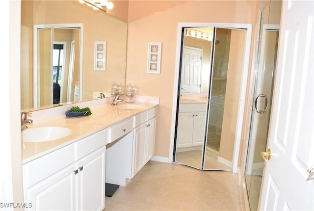 bathroom featuring double vanity, a sink, and tile patterned floors