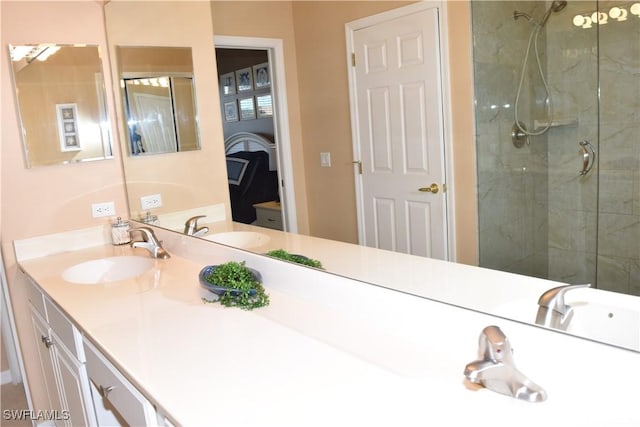 bathroom with tiled shower and vanity