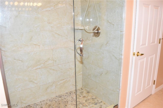 full bath with a tile shower