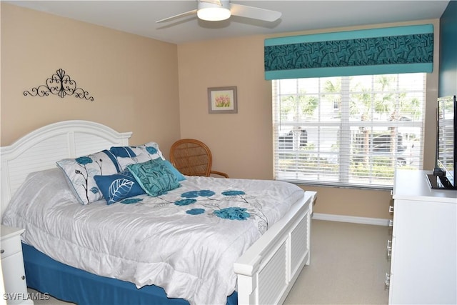 carpeted bedroom featuring ceiling fan and baseboards