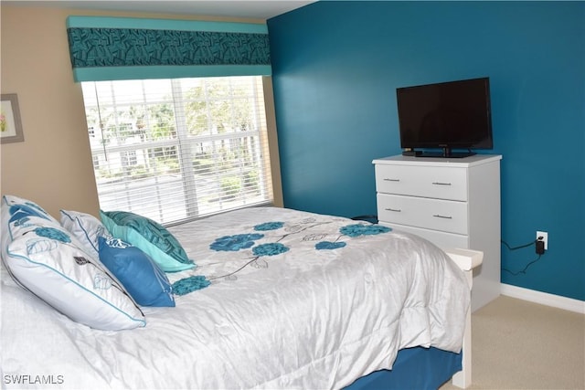 carpeted bedroom with baseboards