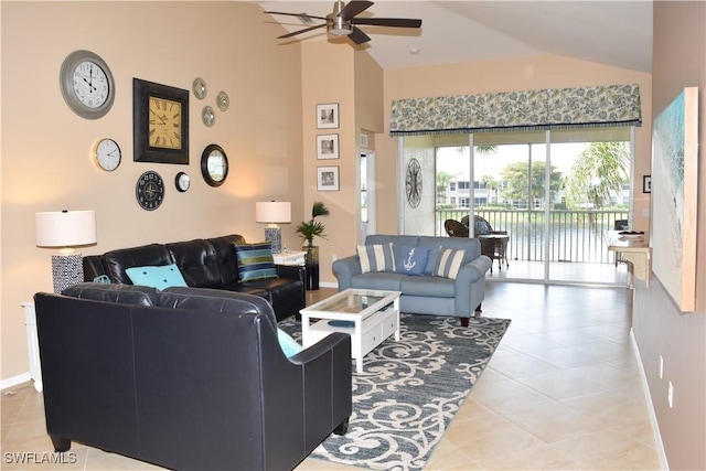 living room featuring ceiling fan, high vaulted ceiling, light tile patterned flooring, a water view, and baseboards