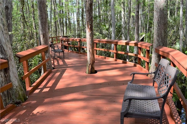 wooden deck featuring a wooded view