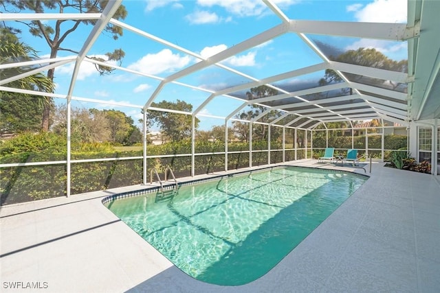 outdoor pool with a patio area and glass enclosure