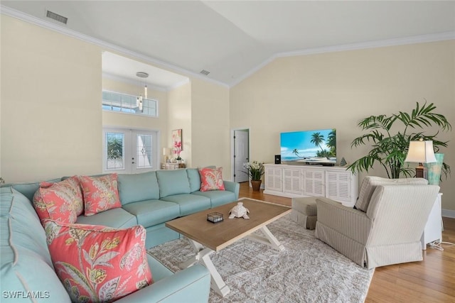 living room featuring french doors, crown molding, visible vents, wood finished floors, and high vaulted ceiling