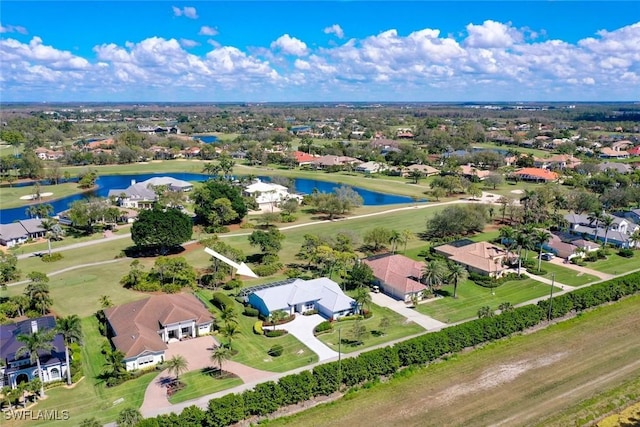 drone / aerial view with a residential view and a water view