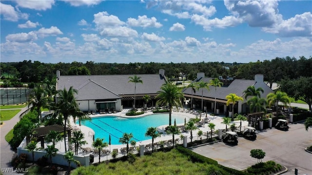 pool with a patio area and fence