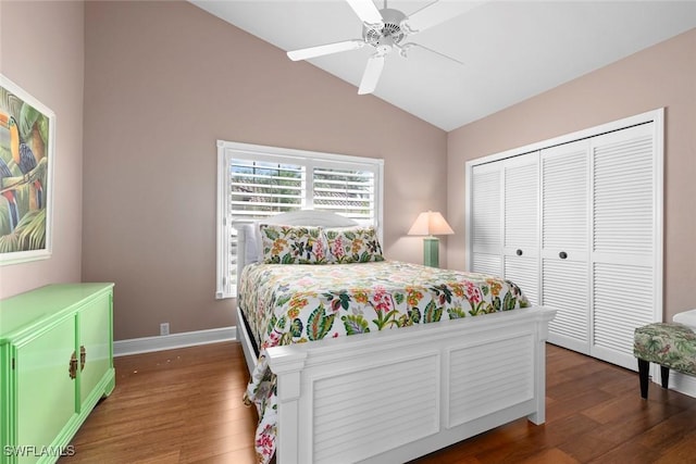 bedroom featuring lofted ceiling, a closet, baseboards, and wood finished floors