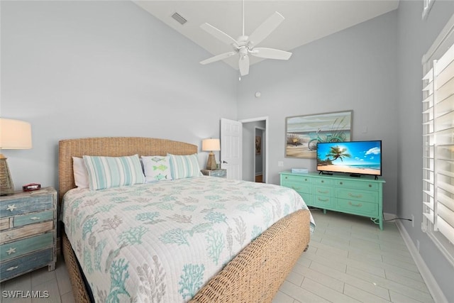 bedroom with high vaulted ceiling, baseboards, visible vents, and ceiling fan