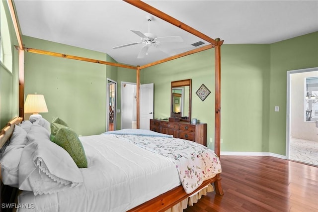 bedroom featuring lofted ceiling, ceiling fan, wood finished floors, visible vents, and baseboards