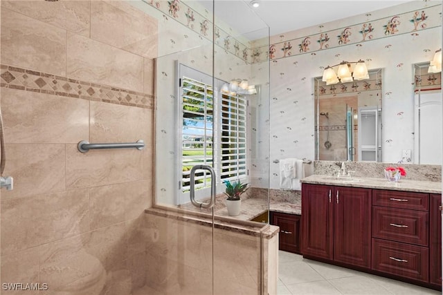 full bathroom featuring a stall shower, vanity, and tile patterned floors