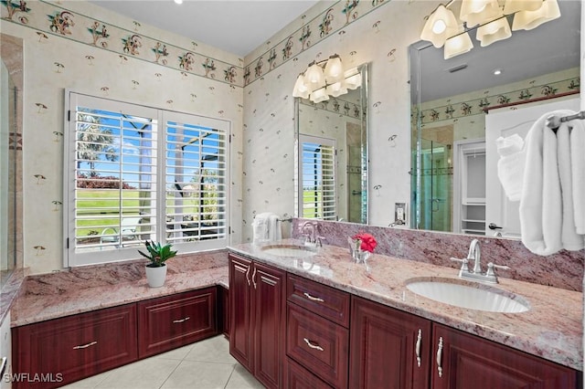 bathroom with double vanity, wallpapered walls, a shower stall, and a sink