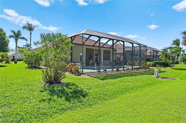 rear view of house featuring an outdoor pool, glass enclosure, a yard, and stucco siding