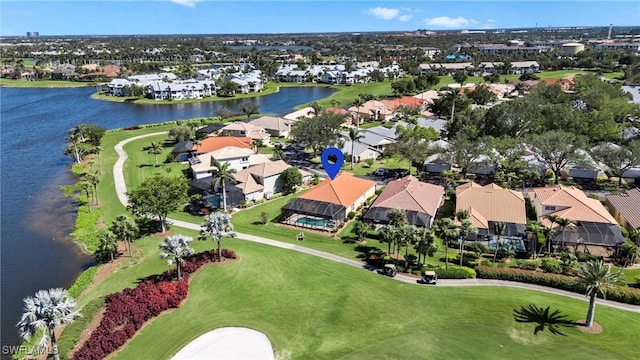 birds eye view of property featuring a water view, view of golf course, and a residential view