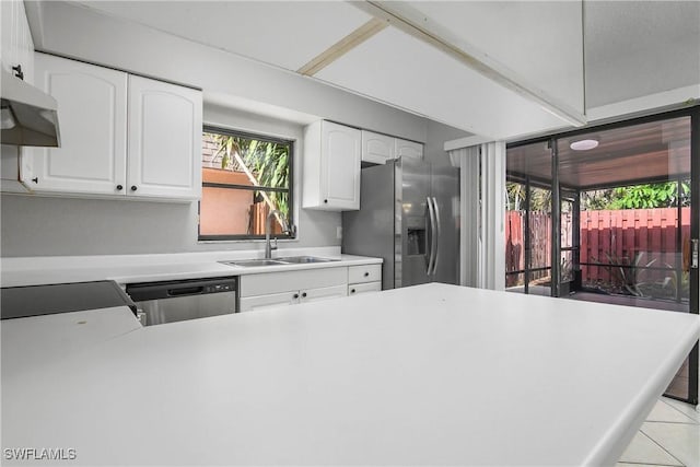 kitchen with white cabinetry, appliances with stainless steel finishes, light countertops, and a sink