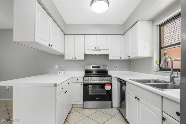 kitchen featuring light tile patterned floors, stainless steel appliances, white cabinetry, a sink, and under cabinet range hood