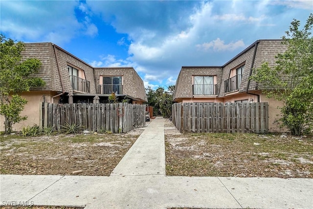 view of home's community featuring fence