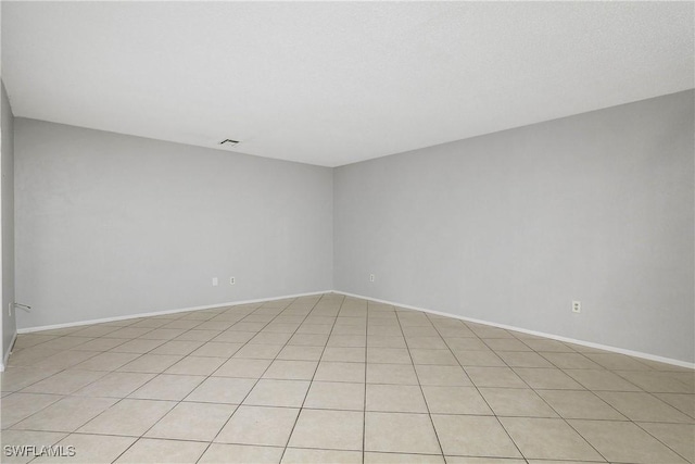 empty room with baseboards and visible vents