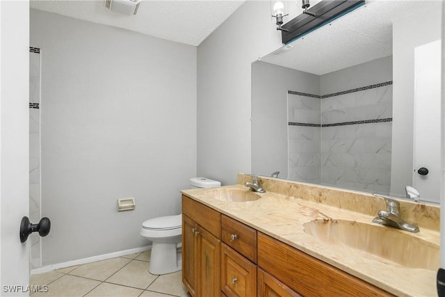 bathroom featuring double vanity, visible vents, toilet, a sink, and tile patterned flooring