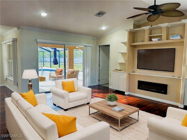 living area with ornamental molding, wood finished floors, and visible vents