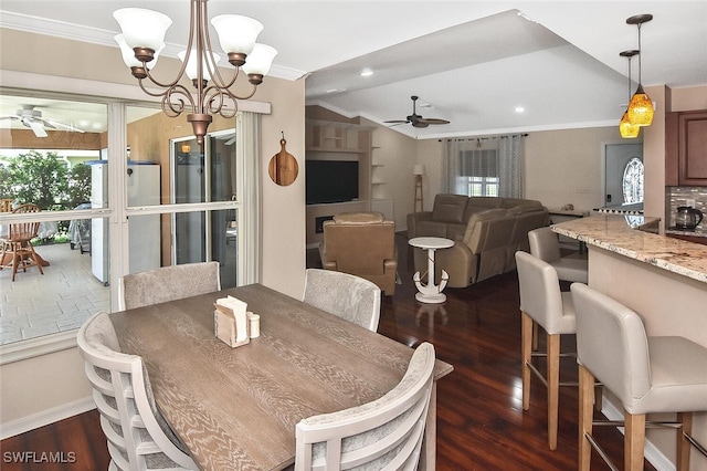 dining area featuring ornamental molding, dark wood-style flooring, and ceiling fan with notable chandelier