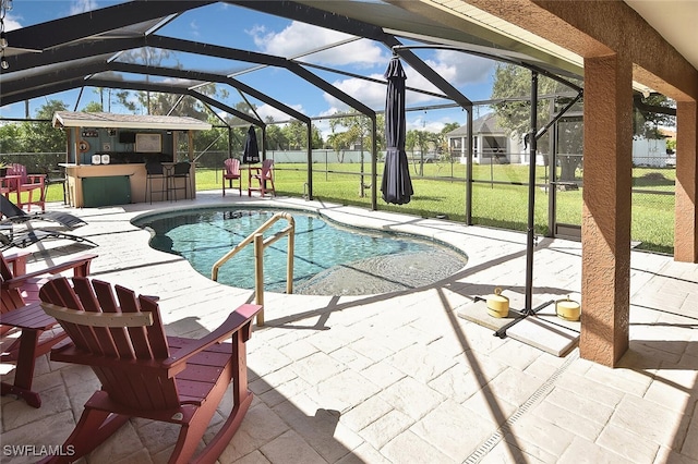 pool featuring outdoor dry bar, a yard, a patio area, and glass enclosure