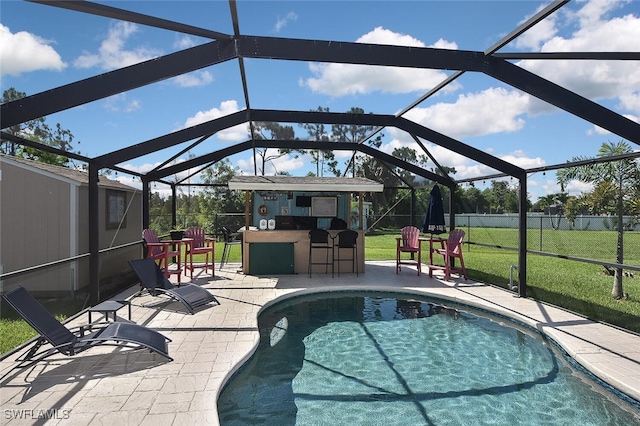 pool featuring outdoor dry bar, a lawn, a patio area, fence, and a lanai