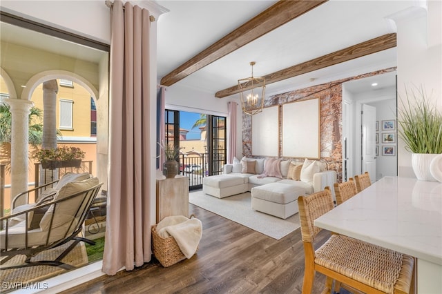 interior space with a notable chandelier, dark wood-style floors, decorative columns, and beam ceiling