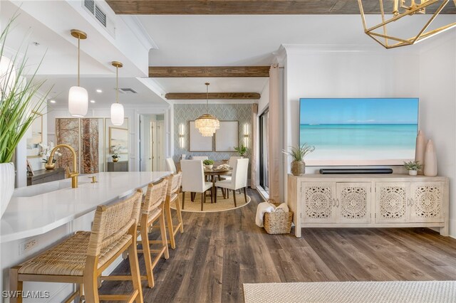 dining space featuring a notable chandelier, visible vents, wood finished floors, and beamed ceiling