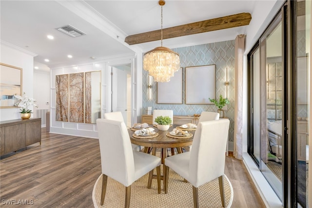 dining space with wood finished floors, visible vents, ornamental molding, beam ceiling, and wallpapered walls