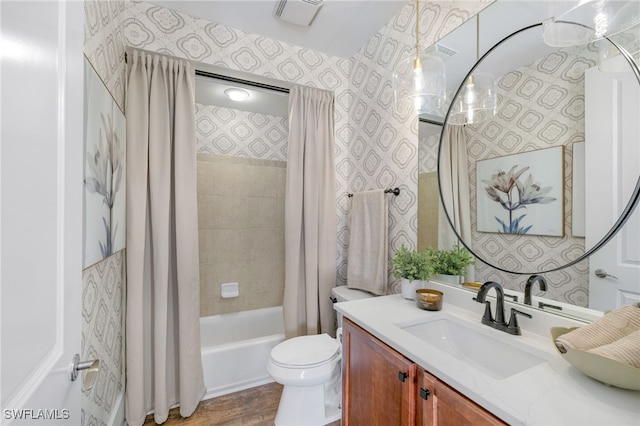 bathroom with toilet, vanity, visible vents, shower / bath combo with shower curtain, and wallpapered walls