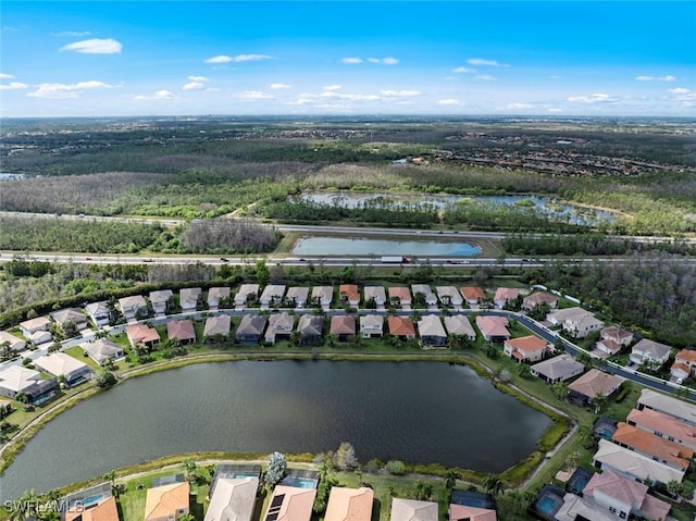 drone / aerial view with a water view and a residential view