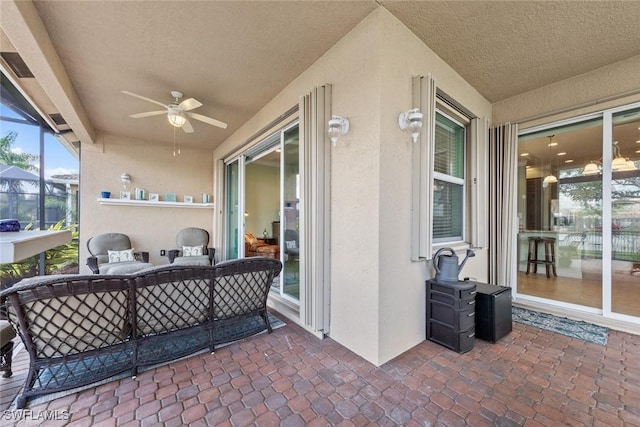 sunroom with a ceiling fan