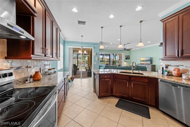 kitchen with stainless steel appliances, visible vents, ornamental molding, a sink, and wall chimney exhaust hood