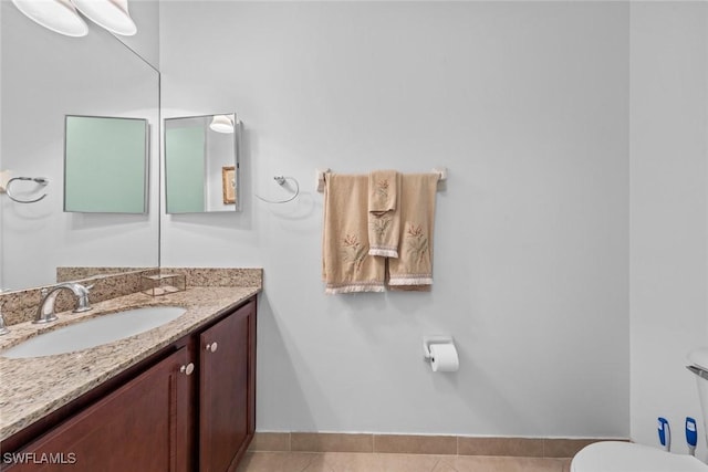 bathroom featuring vanity, toilet, and tile patterned floors