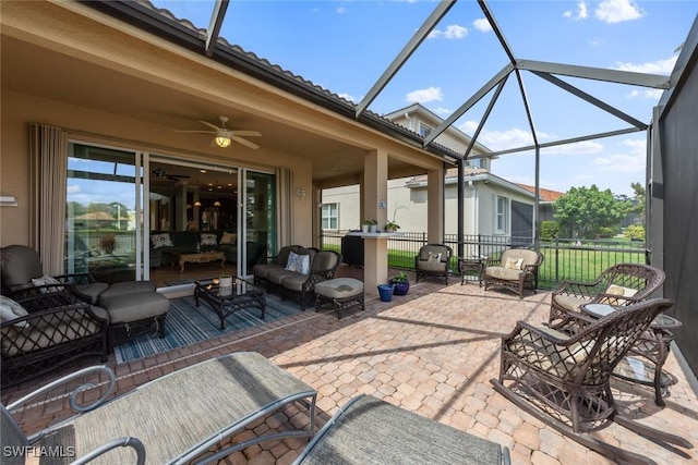 view of patio / terrace featuring ceiling fan, glass enclosure, and outdoor lounge area