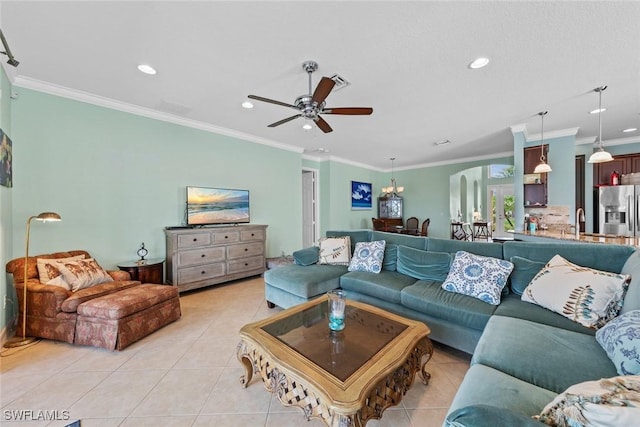 living area with light tile patterned floors, recessed lighting, ceiling fan with notable chandelier, visible vents, and ornamental molding