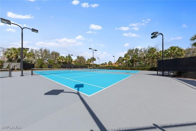 view of sport court featuring fence