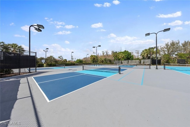 view of sport court featuring fence