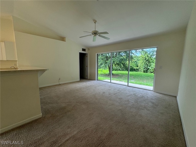 unfurnished room with lofted ceiling, light colored carpet, ceiling fan, and baseboards