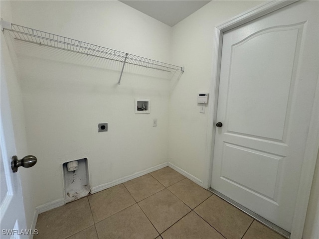 laundry room featuring light tile patterned floors, hookup for an electric dryer, laundry area, washer hookup, and baseboards