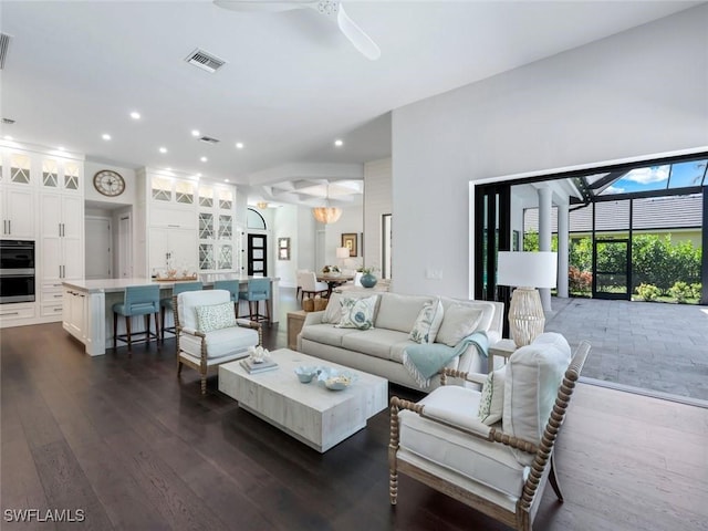 living room with a ceiling fan, recessed lighting, visible vents, and dark wood finished floors