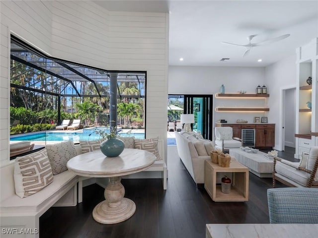 interior space featuring ceiling fan, recessed lighting, beverage cooler, a sunroom, and dark wood-style floors