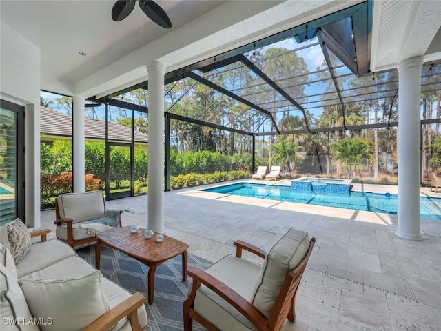 view of pool featuring a patio, a pool with connected hot tub, outdoor lounge area, a ceiling fan, and glass enclosure