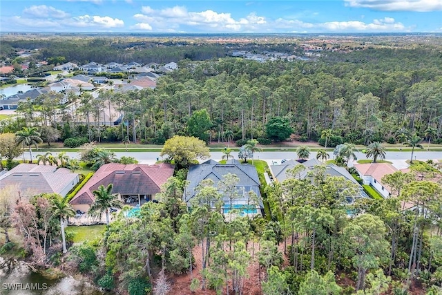 birds eye view of property with a forest view and a residential view